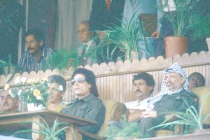 Al-Qaddafi and Arafat at the 19th Anniversary of the Libyan Revolution, August 1988. (Corbis Images/Bernard Bisson)