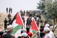 Palestinians and International Solidarity members during the weekly protest against the Apartheid Wall on the land of Ni'lin, Ramallah, West Bank. October 2009 (photo: Hindi Musleh/BADIL)